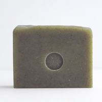 Bar of Mint soap with TONIC's logo stamped in the center, unwrapped, and on a white background.