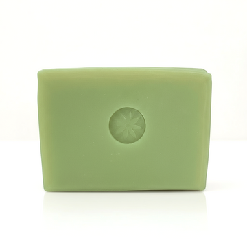 A bright green Neroli soap bar unwrapped on a white background