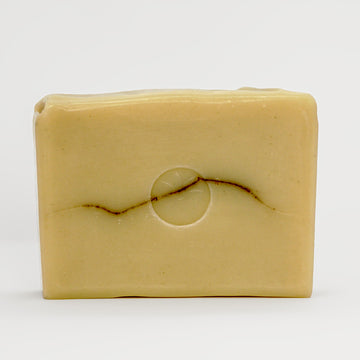 Bay Laurel Bar Soap unwrapped on an off white background