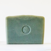 Blue Tansy Bar Soap for face and sensitive skin. Unwrapped, stamped with TONIC's logo, on a white background