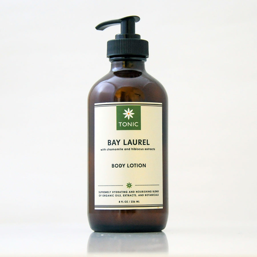 Bay Laurel Body Lotion with Chamomile and Hibiscus Extracts by TONIC in an amber glass bottle with a black pump on an off white background