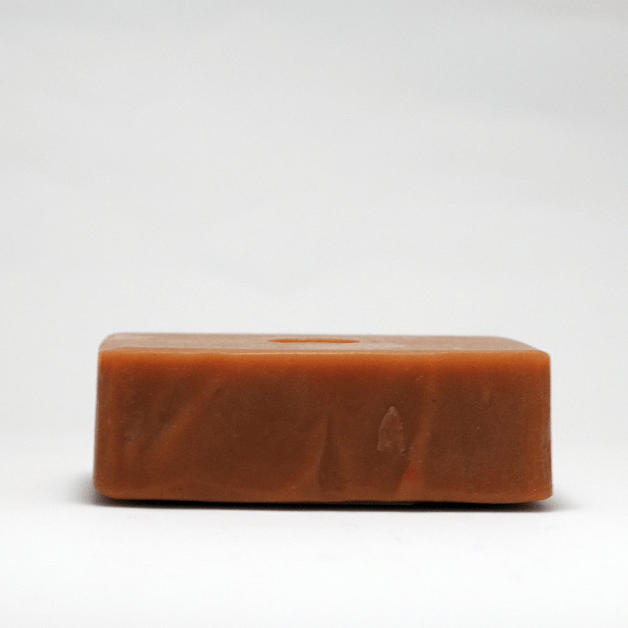 Top view of an unwrapped Chamomile Carrot Bar Soap with Passionfruit, Turmeric, and Honey