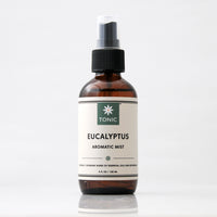 TONIC Eucalyptus Aromatic Mist Room Spray in an amber glass bottle with black pump top and clear cap against a light grey background