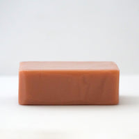 Top view of a TONIC Grapefruit Bar Soap on an off white background