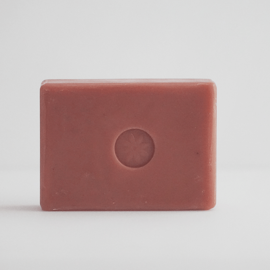 Tonic Naturals Papaya Bar Soap unwrapped on an off white background