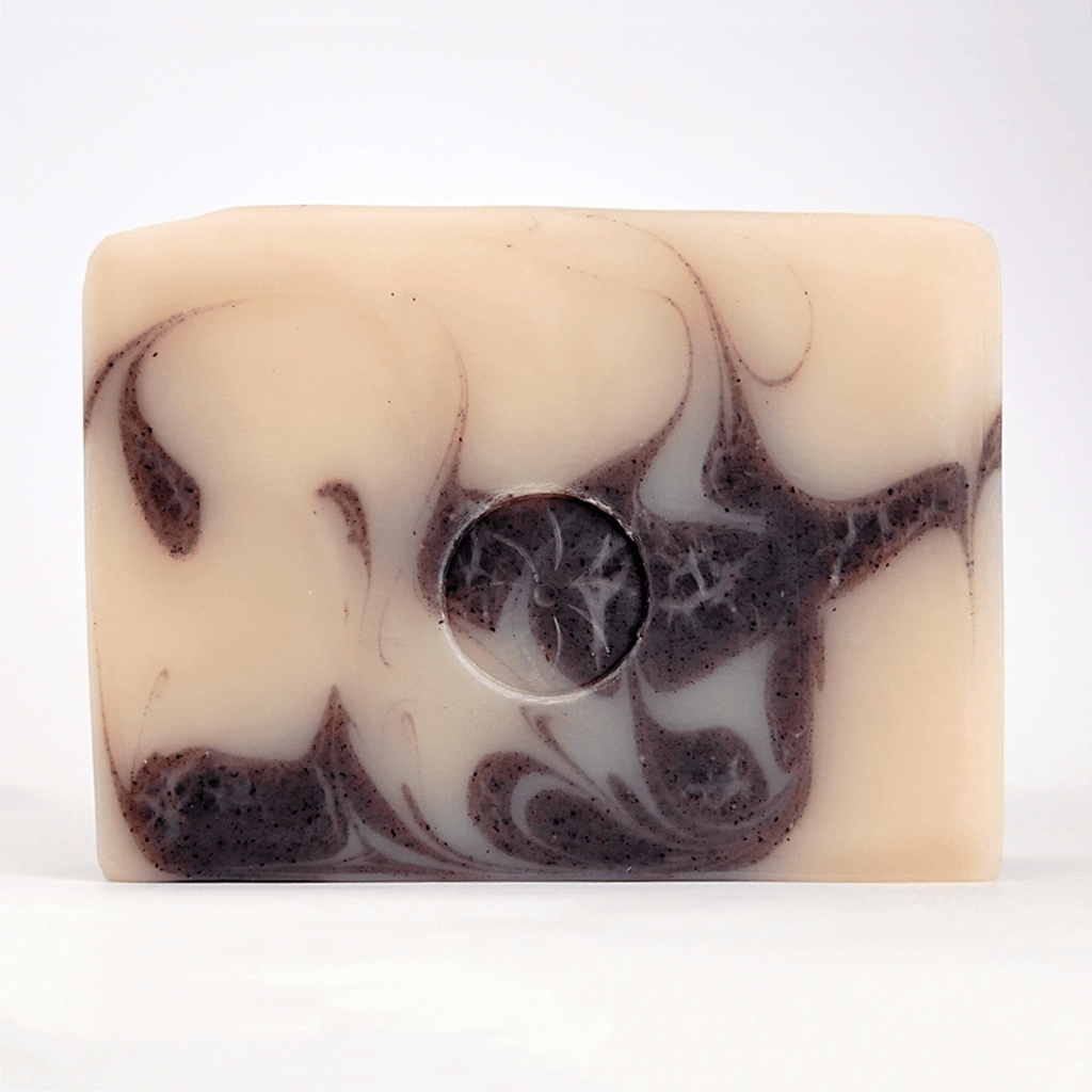 Tonic Naturals Patchouli Bar Soap unwrapped on an off white background.