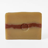 Rockrose Bar Soap, unwrapped and displaying TONIC's logo stamp