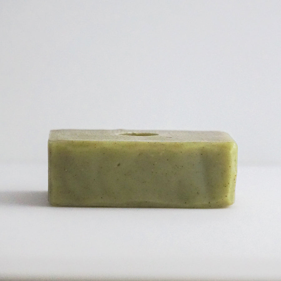Top view of Mint with Clary Sage Bar Soap unwrapped and on an off-white background,