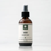 Sage Aromatic Room Spray in a glass amber bottle with a black pump on an off white background