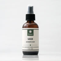 Sage Aromatic Room Spray in a glass amber bottle with a black pump on an off white background