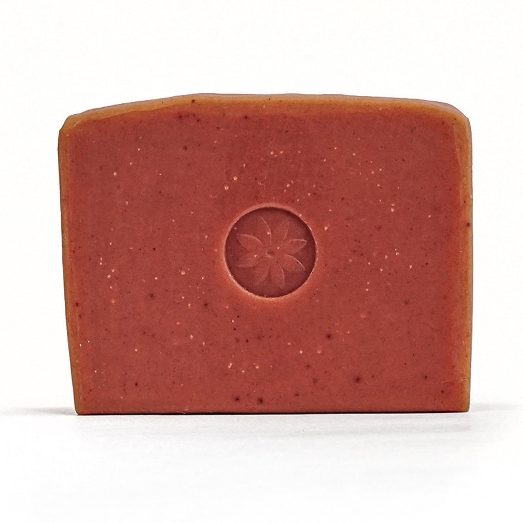 Ylang Ylang bar soap unwrapped on a white background